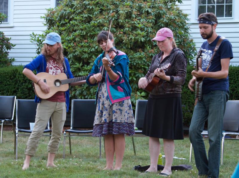 Walking musicians Mark Kilianski, Amy Alvey, Raianne Richards and Mark Mandeville perform for a crowd gathered on the lawn of the Mattapoisett Congregational Church. BY GEORGIA SPARLING